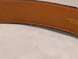 a close up of a brown leather belt with a gold buckle