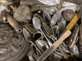 a box full of silver spoons and other silverware