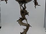 a metal vase with a dragon on it on a table