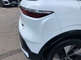 the rear end of a white suv parked in a parking lot