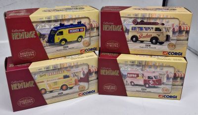 four boxed boxes of toy vehicles are sitting on a white surface