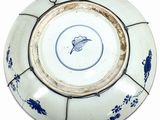 a blue and white plate with a flower design on it