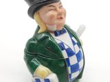une figurine représentant un homme avec un haut-de-forme et une canne