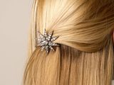 blond woman with long blond hair wearing a star shaped hair clip