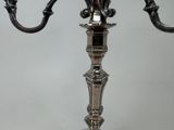 a silver candelab that is on a table