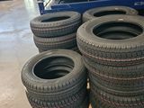 several tires are stacked on a pallet in a warehouse