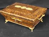 an old wooden box sitting on top of a black surface