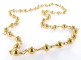a close up of a gold beaded necklace on a white background
