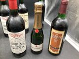 several bottles of wine are lined up on a counter