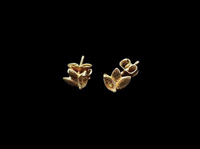 une paire de boucles d'oreilles en or sur fond noir