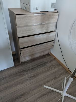 a lamp that is on a stand next to a dresser