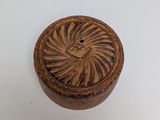 an image of a wooden box with a carved design on it