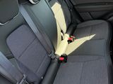 the back seats of a car with a black seat belt
