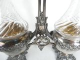 two glass vases on a table with a silver base