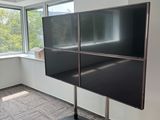 a large flat screen tv sitting on a stand in a room