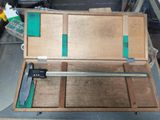 a wooden box with a ruler in it on a workbench