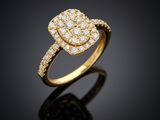 a yellow gold ring with diamonds on a black background
