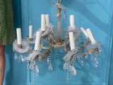 a chandelier hanging from the ceiling in a blue room