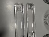 three empty glass bottles sitting on top of a refrigerator