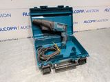 a tool in a blue case on a white surface
