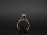 an 18k white gold ring set with a round brilliant cut diamond