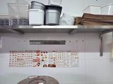 a small kitchen with a lot of clutter on the shelves