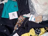 a lot of clothes that are sitting on a table