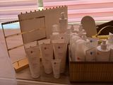 bottles of lotion and lotion sitting on a window sill in front of a window