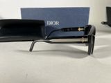 christian dior sunglasses with box and case on table