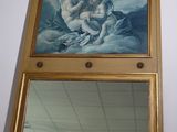 a picture of a painting on the wall above a mirror