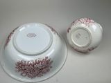 a white bowl and a red and white bowl on a table