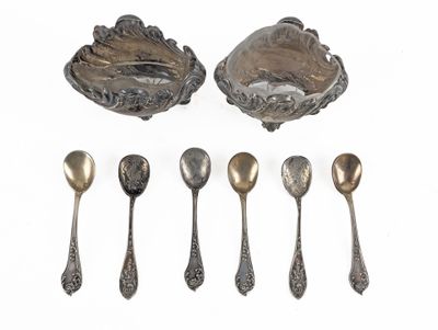 six silver spoons and a bowl with spoons on a white surface