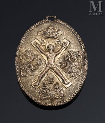 an image of a gold medal with a crown and cross on it
