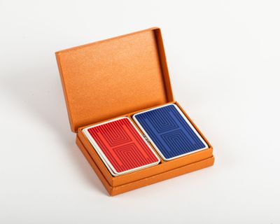 an image of two playing cards in a box on a white surface