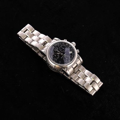 a watch that is sitting on a black surface