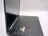 a black laptop with a silver keyboard on a white surface