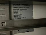 a picture of a metal shelf with a sign on it