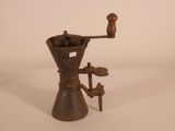 an old coffee grinder on a white surface