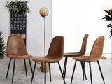four chairs sitting in a room with a clock on the wall