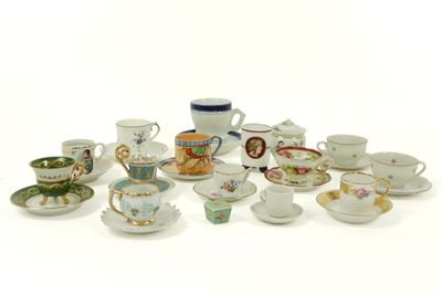 many cups and saucers sitting on a white surface