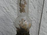 an old fashioned oil lamp that has been turned green