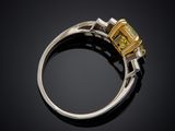 a yellow sapphire and diamond ring on a black background