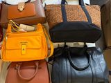a lot of purses that are sitting on a table