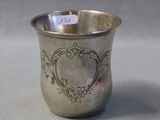 a silver cup that is sitting on a table