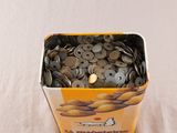 a bucket of coins sitting on top of a table
