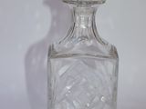 a clear glass bottle with a diamond design on the top