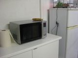 a microwave oven sitting on top of a white cabinet