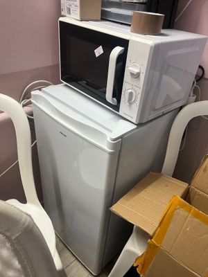 a microwave and a washing machine stacked on top of each other