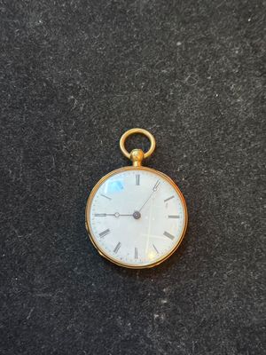 an image of a gold pocket watch with roman numerals and roman numerals on the face
