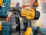 yellow and blue power tools are sitting on a table